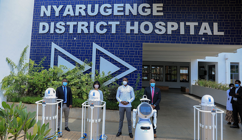 Officials pose behind the three THOR UVC robots donated by the United Nations Development Programme to Rwanda at Nyarugenge District Hospital on Tuesday, February 9. / Photo: Dan Nsengiyumva.