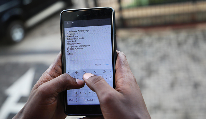 A Mobile Money user makes a transaction. / Photo: Sam Ngendahimana.