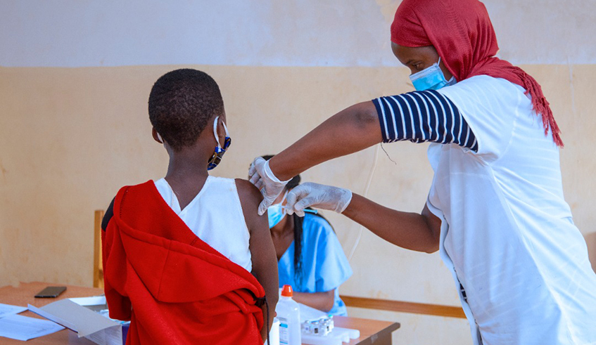 A health worker vaccinates a young girl against cervical cancer in Kigali. Rwanda was the first African country to roll out free HPV vaccination for girls back in 2011. / Photo: Courtesy.