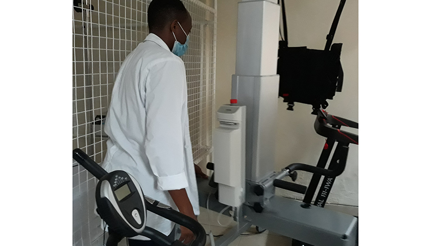 Nshimiyimana, a physiotherapist, shows how a machine used for rehabilitating patients works. / File photo