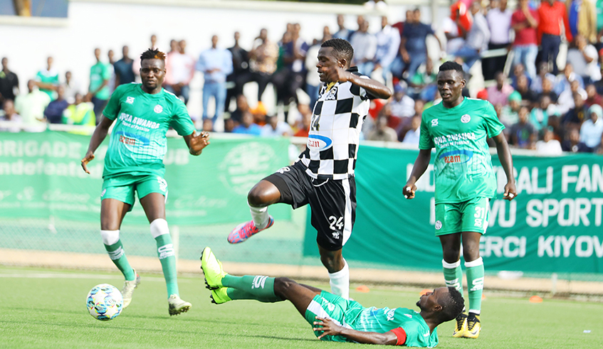APR FC left back Emmanuel Imanishimwe dribbles past SC Kiyovu defenders during a past league match at Kigali Stadium. The Rwanda Premier League was suspended in December to help contain the spread of Covid-19. / Sam Ngendahimana.