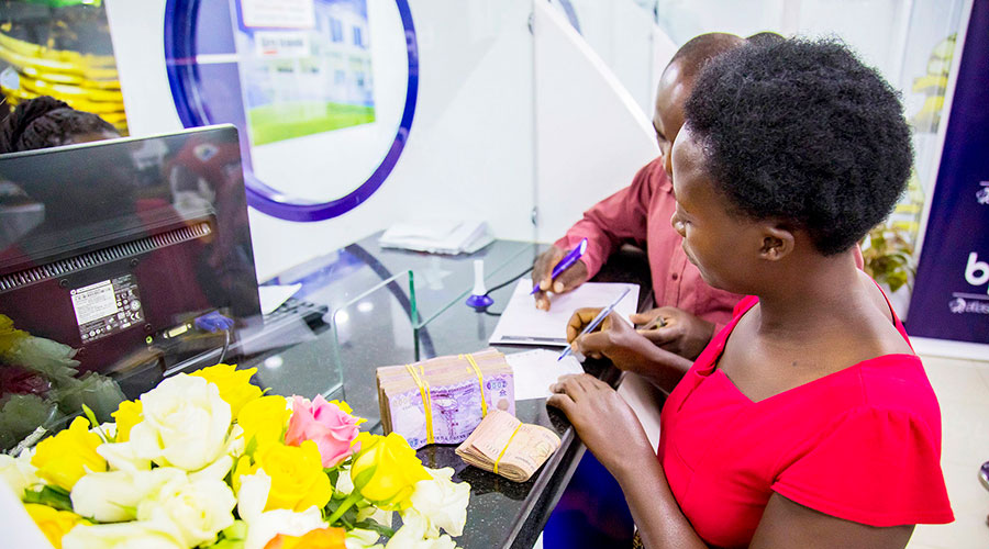 A client makes a transaction at a bank counter in Nyabugogo in 2019. The Central Bank is increasing supervisory oversight on local commercial banks in efforts to make them more prudent. 