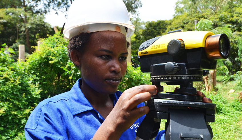 A student in construction engineering uses a survey equipment at a construction site in Kicukiro District in 2019. / Photo: Sam Ngendahimana.