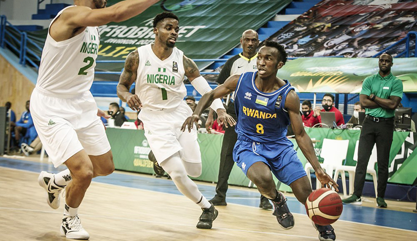 Point guard Nshobozwabyosenumukiza tries to get past two Nigerian players during the recent Afrobasket qualifiers in Tunisia. The 22-year-old was in good form during Rwandau2019s win against South Sudan. / Courtesy.