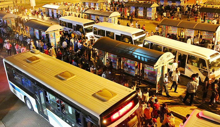Commuters queue to board buses at Kigali downtown taxi park last year. Public services are at the forefront of the pandemic crisis . /  Photo: Craish Bahizi.