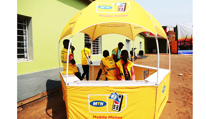 MTN Mobile Money agents at one of their selling points in Kigali. MTN Rwandau2019s fin-tech company will see its mobile money service move to a stand-alone company. / Photo: Sam Ngendahimana.
