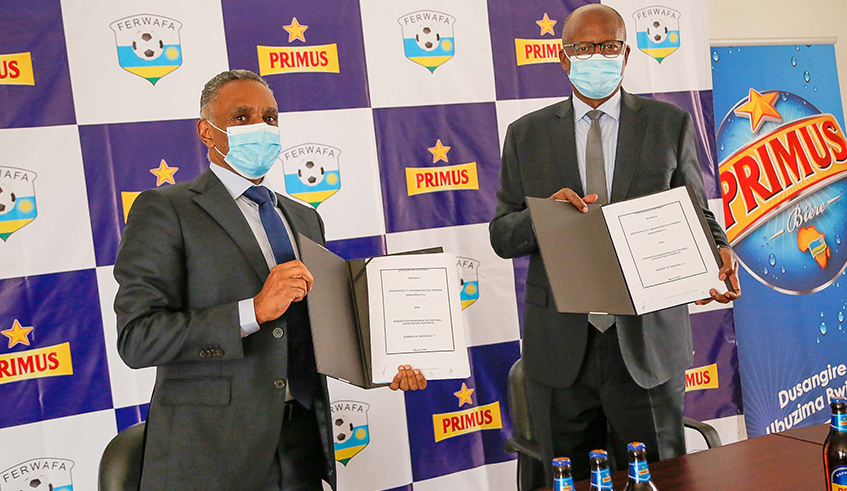 Merid Demissie (L), the Managing Director of Bralirwa, and Ferwafa President Jean-Damascene Sekamana after signing the sponsorship deal on Thursday, March 4, in Kigali. / Courtesy