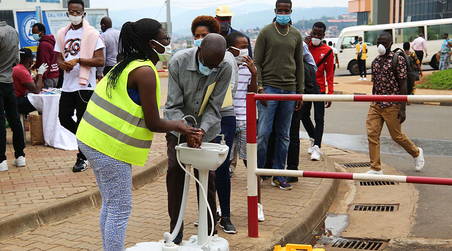 A female member of the youth volunteers helping  citizens respect measures to fight the spread of Covid 19  in Kigali City. 