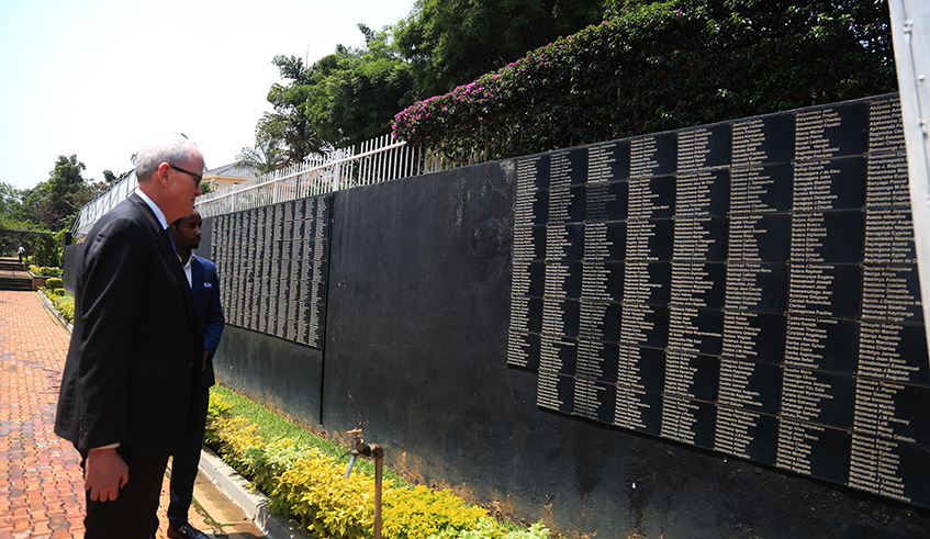 A visitor reads some names of victims of the Genocide Against the Tutsi during his visit at the Kigali Genocide memorial . / Sam Ngendahimana