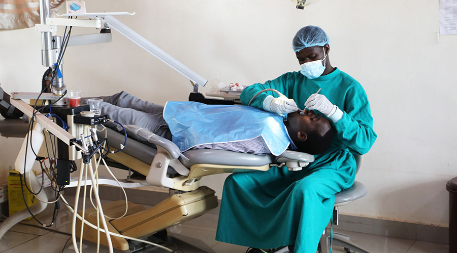 A UR lecturer treats a dental patient on March 19, 2021. The university also partnered with SOS Children's Village to raise awareness of oral health among schoolchildren. 