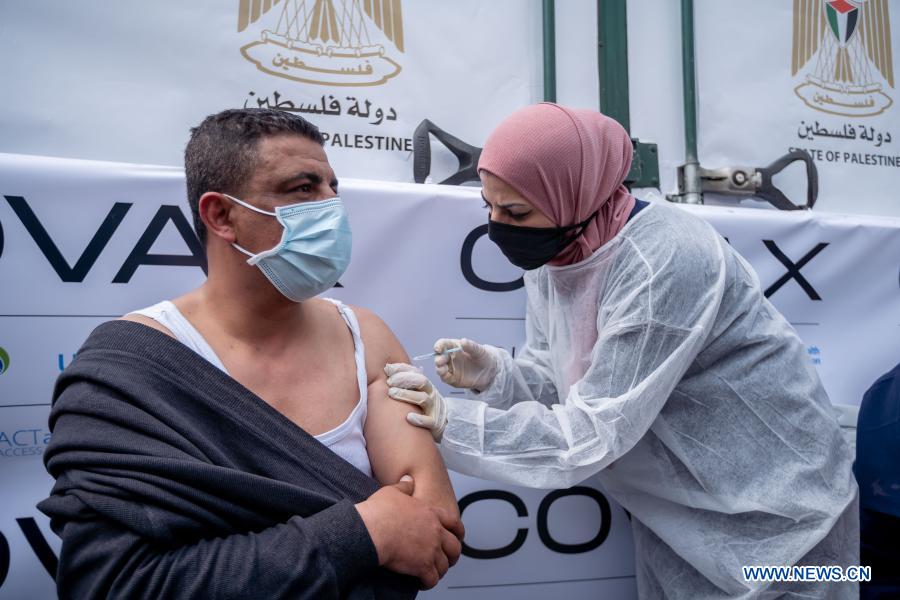 A man receives the COVID-19 vaccine during a vaccination campaign in the West Bank city of Ramallah, on March 21, 2021. 