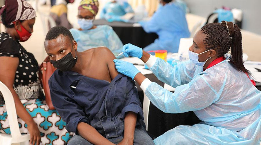 A health worker immunises a person against Covid-19 at Kigali Special Economic Zone on March 13. As the country intensifies the fight against the virus, new variants have been detected. 
