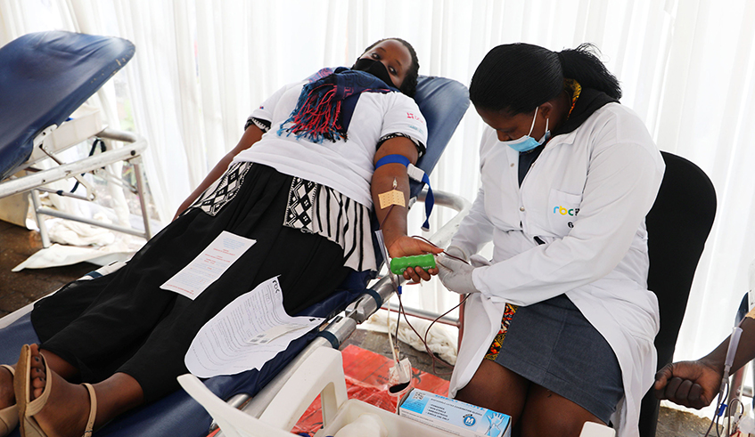 A health worker collects blood from a volunteer during the launch of a week-long blood donation effort dubbed u201cRSSB Kigali Blood Donation Heroes Driveu201d on Monday, March 22. 