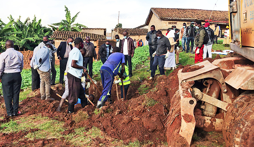 People exhume the remains of the victims of the 1994 Genocide against the Tutsi from a mass grave at the premises of ADEPR church in Gahogo in Muhanga District. Efforts to give genocide victims a decent burial are being undermined by the unwillingness to provide information about their location. / Photo: Courtesy  