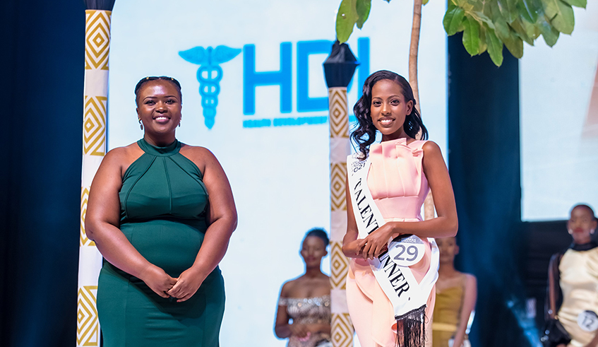 Juliette Karitanyi , Director Of Communications at Health Development Initiative (HDI)  posing for a photo with Miss Talent 2021 Umutoniwase  who was named HDI Youth Ambassador . / Courtesy photo