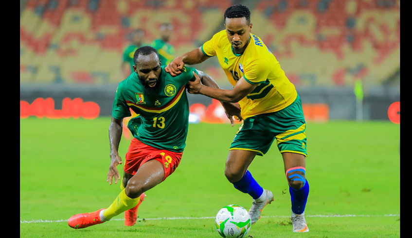 Amavubi midfielder Yannick Mukunzi tries to get past Cameroonian defender Nicolas Moumi during the Africa nations cup qualifier on Tuesday. / Photo: Courtesy..