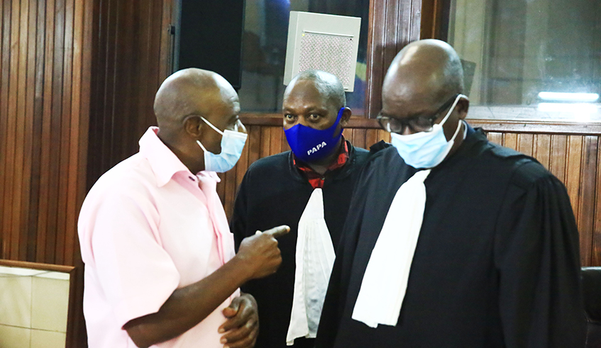 Rusesabagina interacts with his lawyers Gatera Gashabana and Rudakemwa during the hearing on February 26,2021. / Sam Ngendahimana