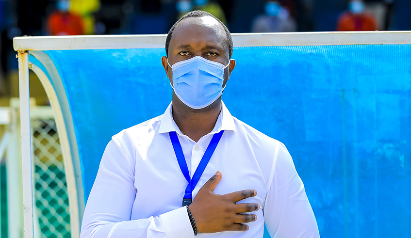 Vincent Mashami, Amavubi head coach observes the national anthem during an African Nations Cup qualifier against Mozambique at Kigali stadium recently. The 38-year-old is now eyeing the World Cup qualifiers which kicks off in June. / Courtesy.
