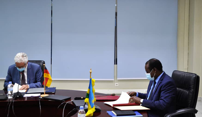 Thomas Kurz, the Ambassador of the Federal Republic of Germany to Rwanda and Uzziel Ndagijimana, the Minister of Finance and Economic Planning sign the agreement in Kigali on April 12 . / Courtesy
