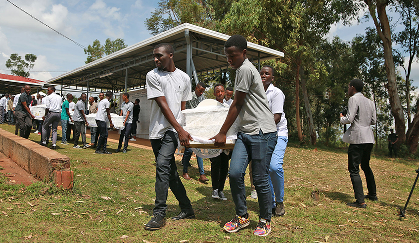 Youth carry remains of Genocide victims that were exhumed from different mass graves during an event to give them a decent burial at Nyanza-Kicukiro Genocide Memorial in 2019. / All photos: Sam Ngendahimana.