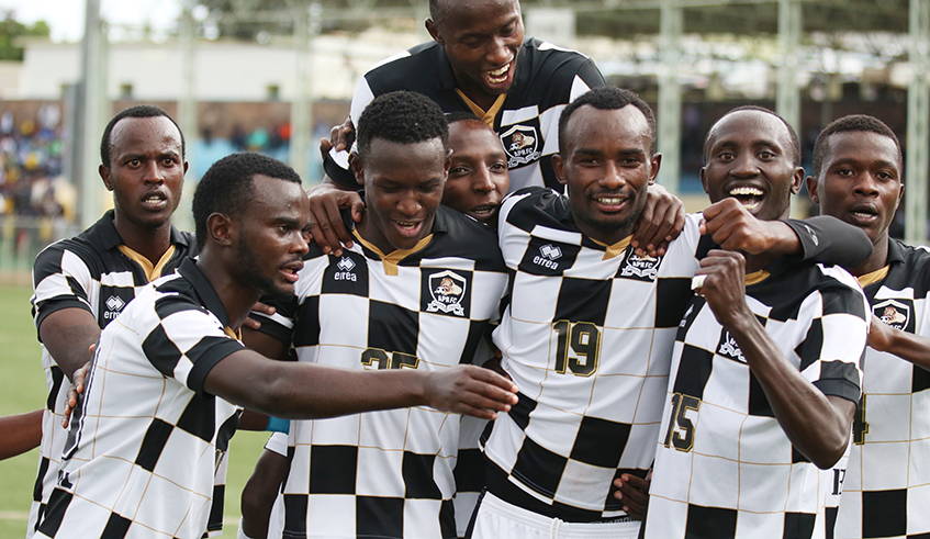 APR FC skipper Thierry Manzi (in the background) celebrates with his teammates during a league match in 2019. The defender has warned against complacency when the league resumes this weekend. / Sam Ngendahimana.
