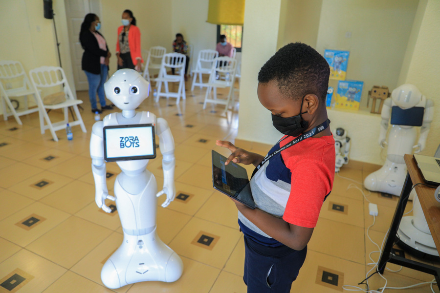 A child learns to control a robot using a tablet at his young age at Zorabots office in Gasabo District on April 24, 2021. 