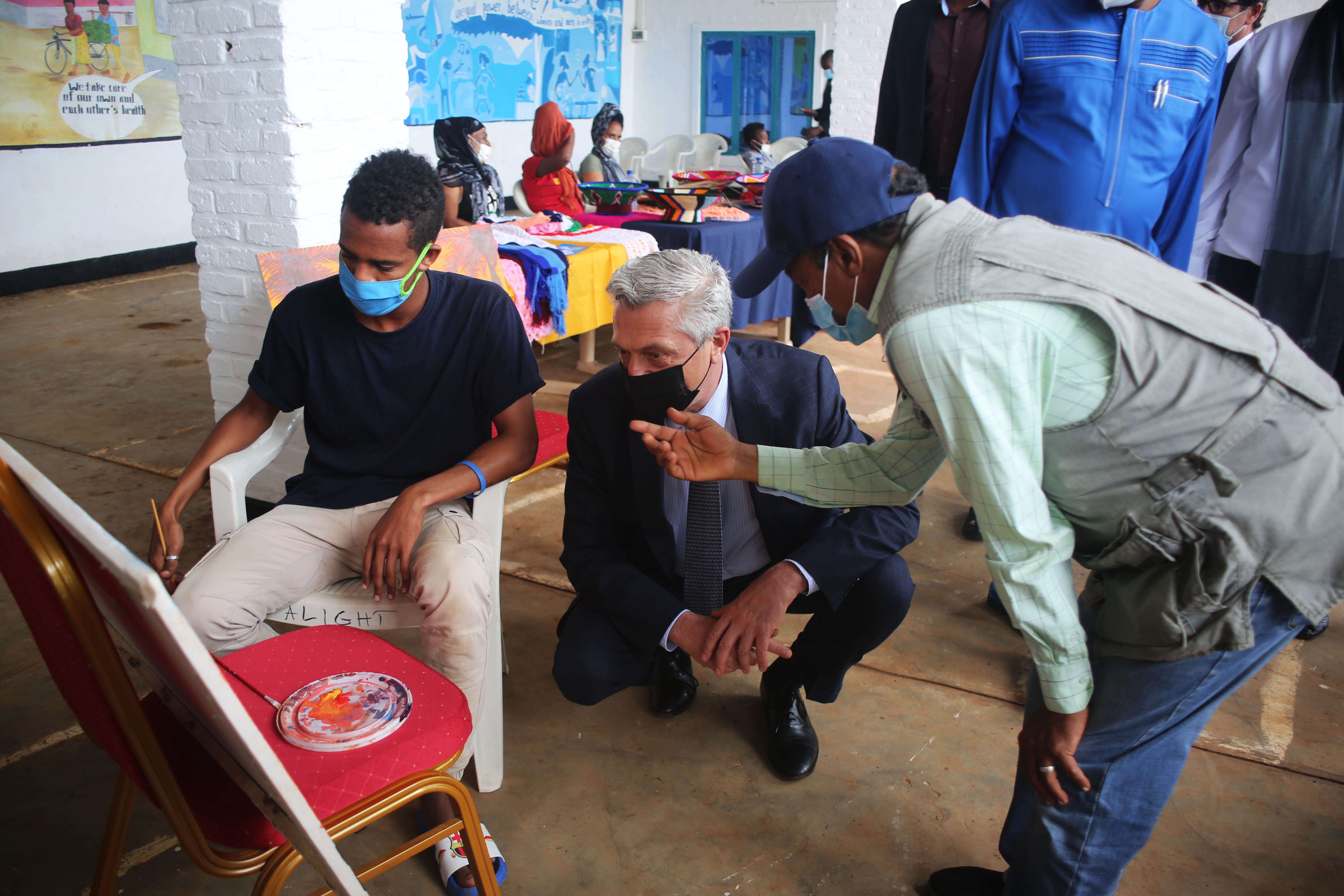 UN High Commissioner for Refugees, Filipo Grandi (centre) looks on as one of the asylum seeker at Gashora Emergency Transit Centre in Bugesera district draws a painting. Grandi described the centre as a lifesaving facility which has given a new lease of life to these African nationals. 