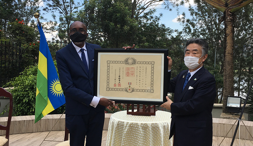 Japanese envoy to Rwanda, Masahiro Imai (R) hands over the decoration of the u2018The Order of the Rising Sun, Gold and Silver rayu2019 award to veteran Karateka Theogene Uwayo for his role in promoting the sport in Rwanda. / Courtesy.