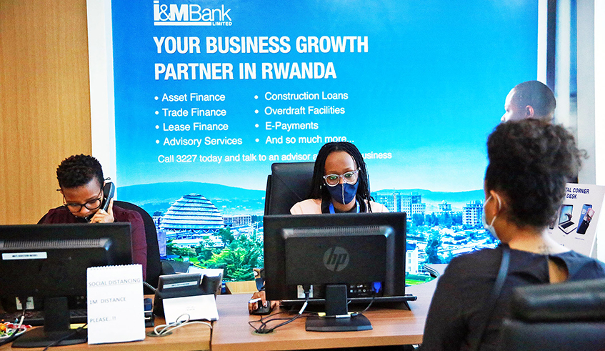 I&M Bank Rwanda staff attend to a clinet at Kigali Height branch last year. The  approved and adopted issuance of a one new fully-paid-up bonus share of a stated value of Rwf10 for every four ordinary shares held. / Photo: Sam Ngendahimana.