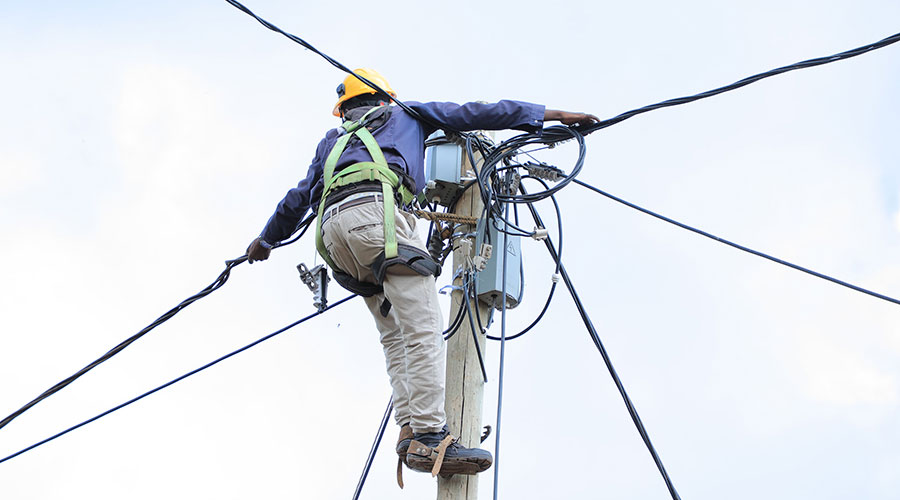 A REG technician connects households to the national grid last year. 