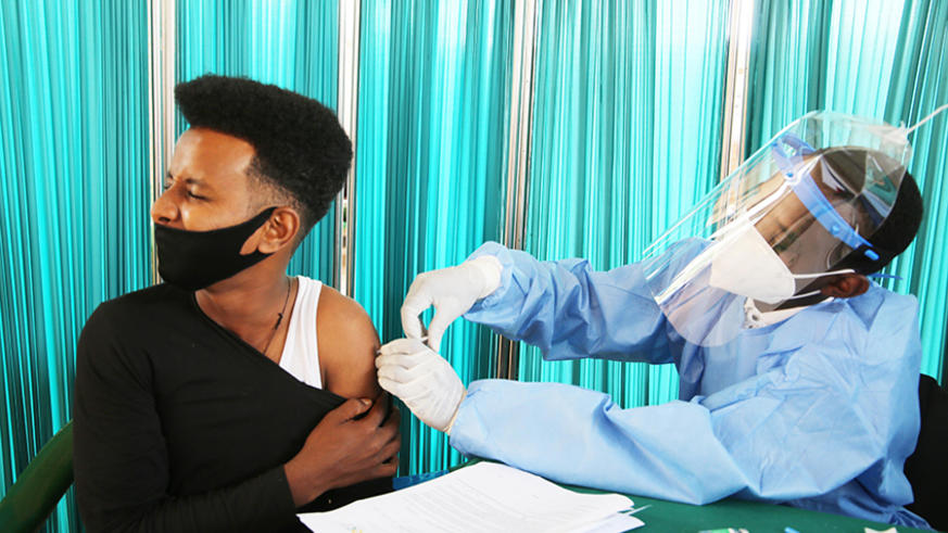 An assylum seeker from Libya gets his first dose of Covid 19 vaccine at Gashora Transit Center in March 2021 . / Craish Bahizi