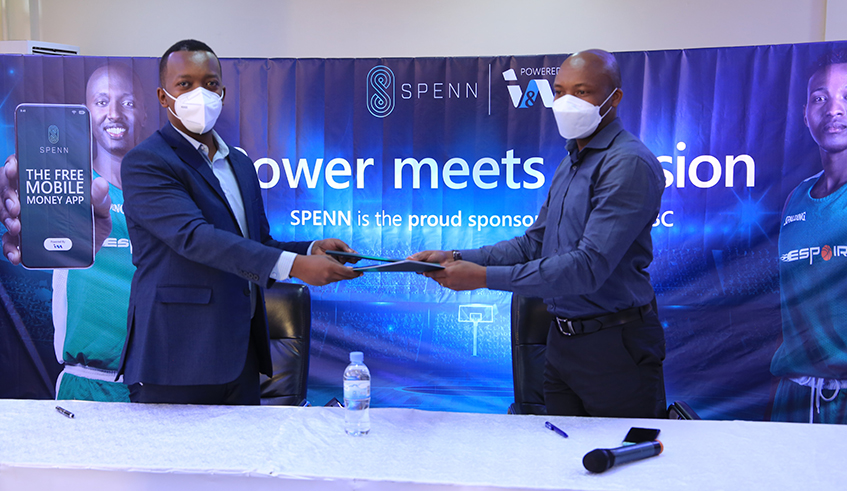 Norbert Haguma, the Country Manager of SPENN Rwanda (L) and Albert Tuyishime, the Vice President of Espoir Basketball club exchange documents after signing a one year partnership deal worth Rwf15m. / Photos: Craish Bahizi.