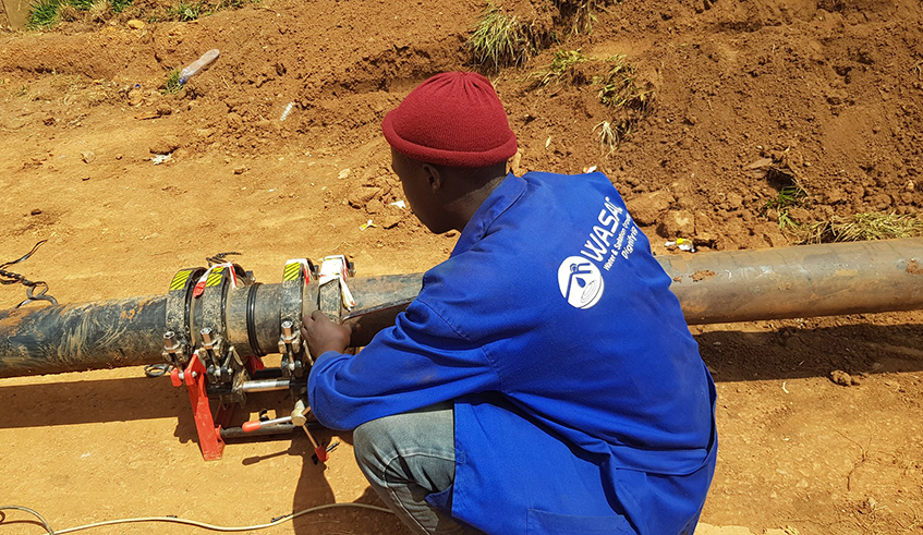 A WASAC technician fixes a water pipe at Kanombe in Kigali. / Photo: Courtesy.
