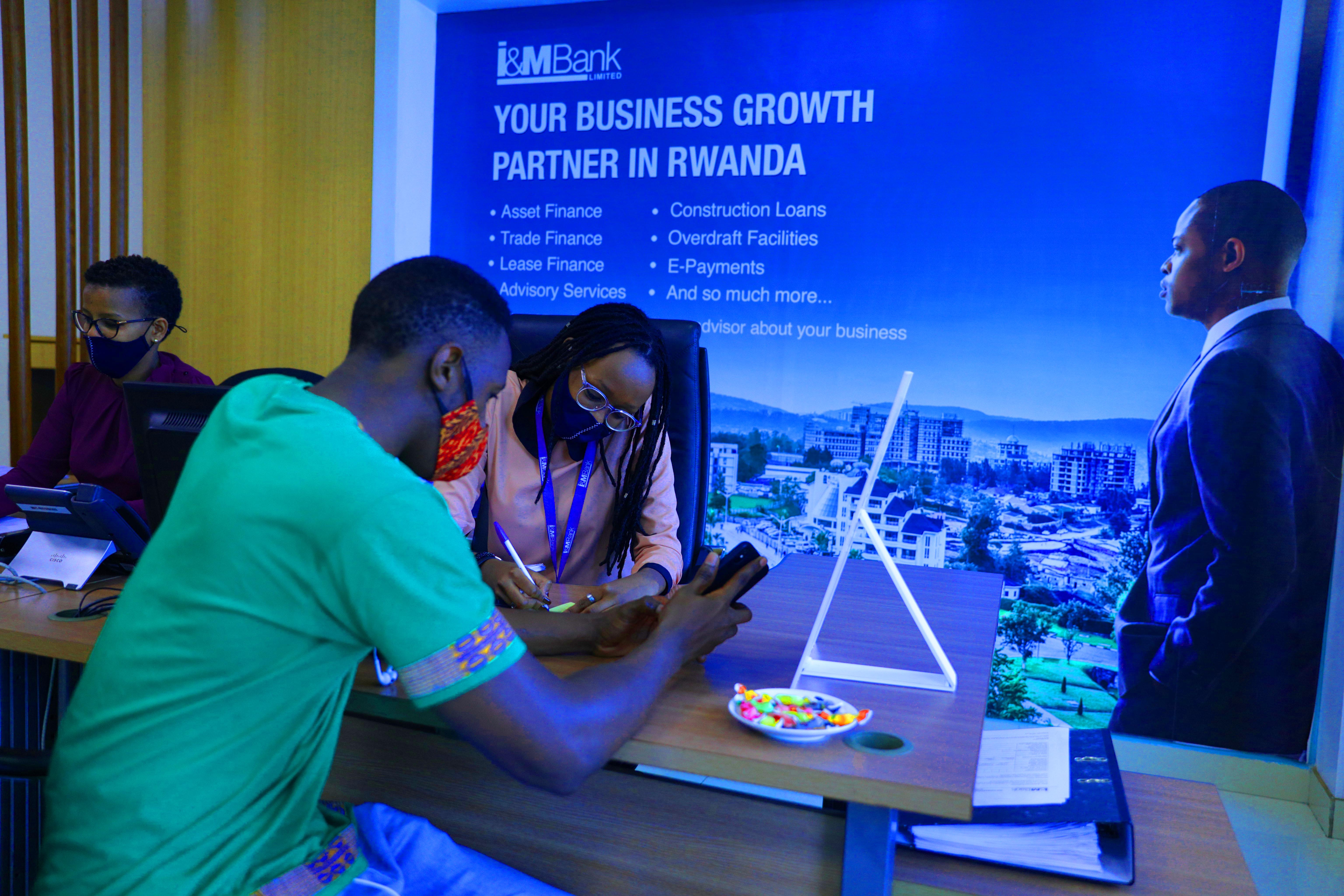 A customer gets some information at I&M Bank, Kigali Heights branch last year. 