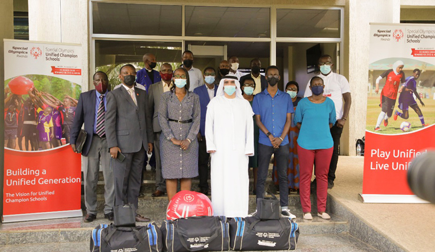 Officials pose for a group photo with sports gear that was donated to students with disabilities. / Photo: Courtesy.