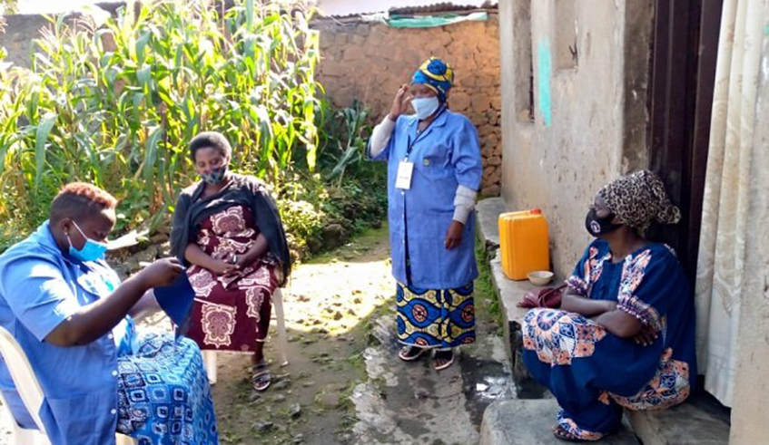 Community health workers during a door to door exercise to sensitize how  to contain a surge in novel coronavirus cases in Kamonyi in April. / Courtesy