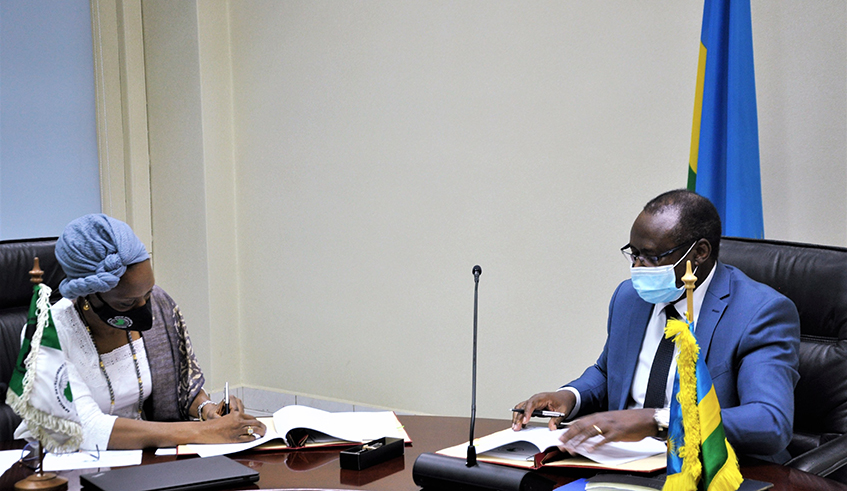 The Minister of Finance and Economic Planning, Uzziel Ndagijimana and Aissa Toure, AfDB Country Manager  sign the agreement in Kigali on June 4. / Courtesy