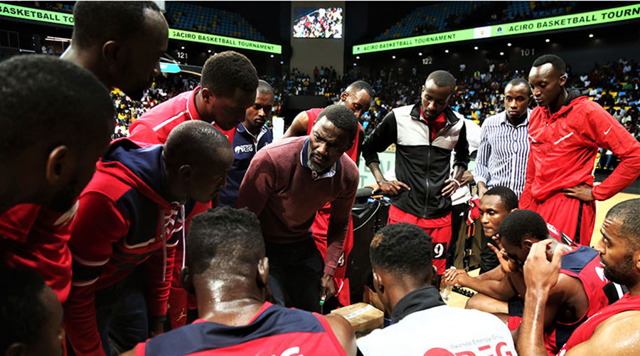 REG head coach Henry Mwinuka (C) gives instructions to his players during a past game at Kigali Arena. 