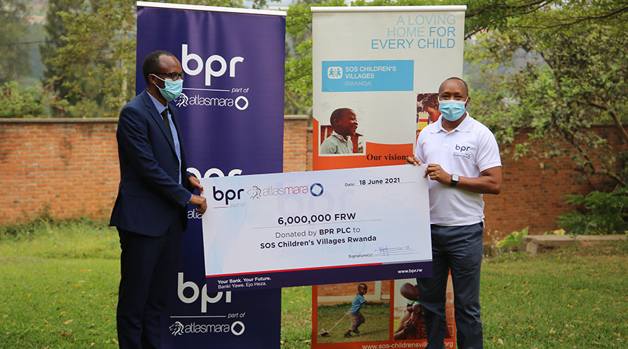 Jean-Bosco Kwizera, National Director of SOS Childrenu2019s Village Rwanda, and Maurice Toroitich, the Managing Director of BPR, during the handover ceremony on June 18. 