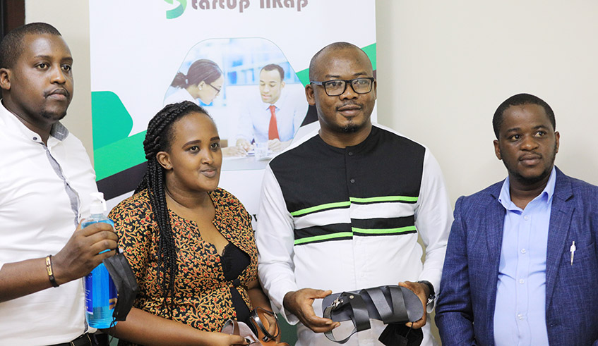 Gilbert Ewehmeh, The Chief Executive of STARTUPu2019NKAP (Center) with beneficiaries of his financially support during an event. / Photo: Sam Ngendahimana.