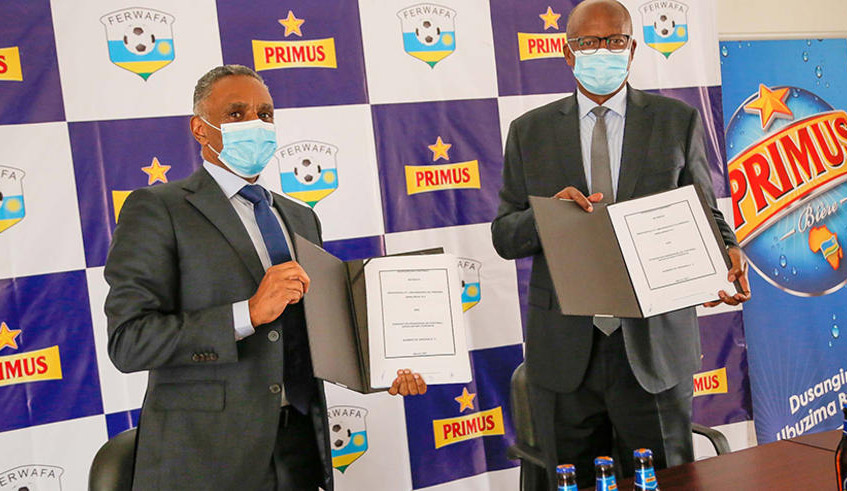 Merid Demissie (L), the Managing Director of Bralirwa, and former Ferwafa President Jean Damascene Sekamana after signing the sponsorship deal on Thursday, March 4, in Kigali. / Courtesy.