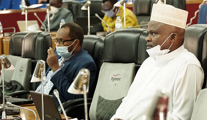 Omar Munyaneza, the chairperson of the Parliamentary Standing Committee on National Budget and Patrimony (right), and other MPs during a plenary session last year. / Photo: Craish Bahizi.