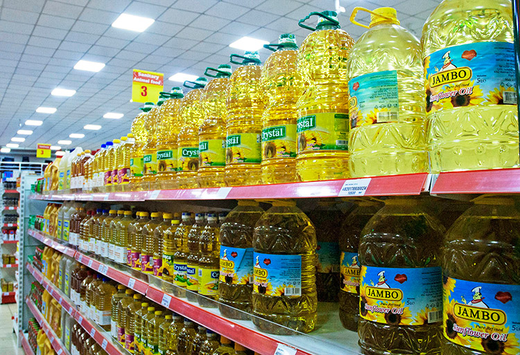 Imported cooking oil bottles on shelves in a supermarket in Kigali. / Photo: Dan Nsengiyumva.