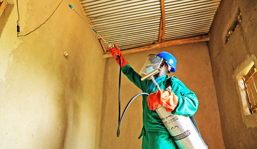 A health worker carries out indoor residual spraying in Bugesera District recently. Rwanda Biomedical Centre has received $53 million from Global Fund to support the fight against malaria. The money will mainly go to indoor residual spraying in six districts for the next three years. / Photo: Dan Nsengiyumva.