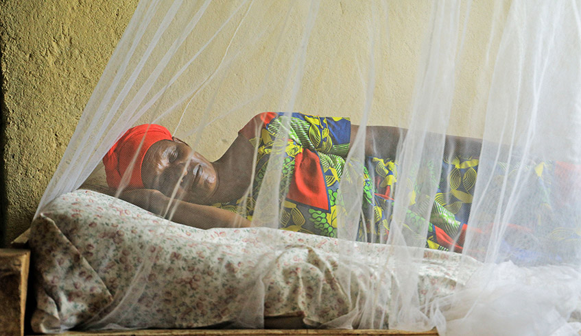A woman sleeps under a mosquito net in Bugesera District. / Photo: Dan Nsengiyumva.