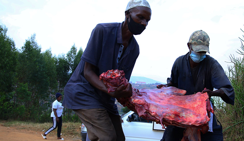 Muslims carry meat to be distributed to muslims to celebrate Eid al-Adha under strict Covid-19 measures in Kamonyi District on July 20. / Photo Sam Ngendahimana