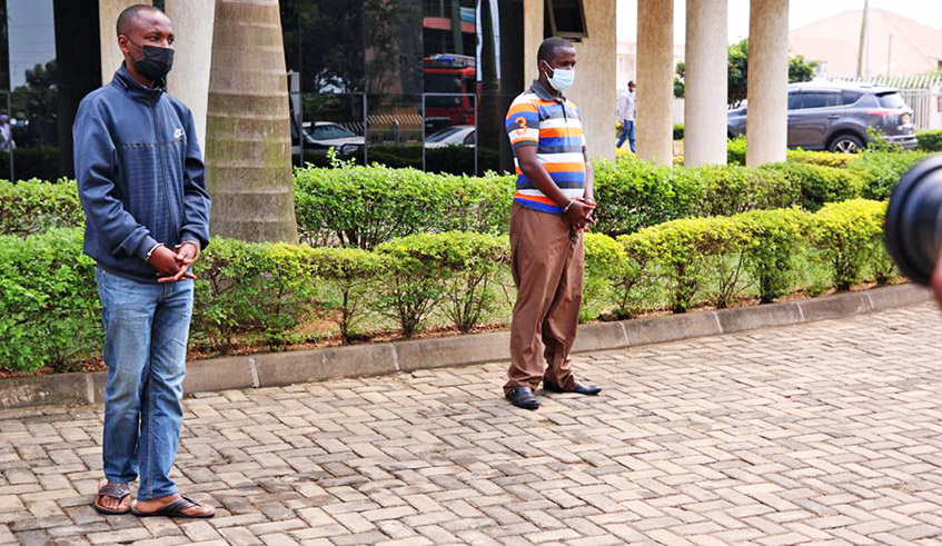 Two suspects of a scam attempt are paraded after they were arrested by Rwanda National Police trying to fleece a man of Rwf15 million on July 15. / Photo: Courtesy.