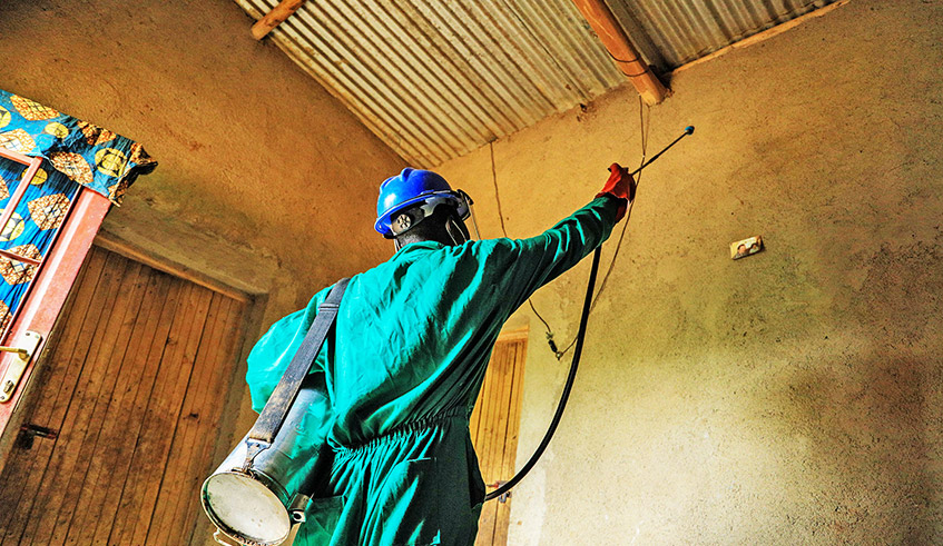 A health worker conducts an indoor residual spraying in Bugesera District. / Photo: Dan Nsengiyumva.