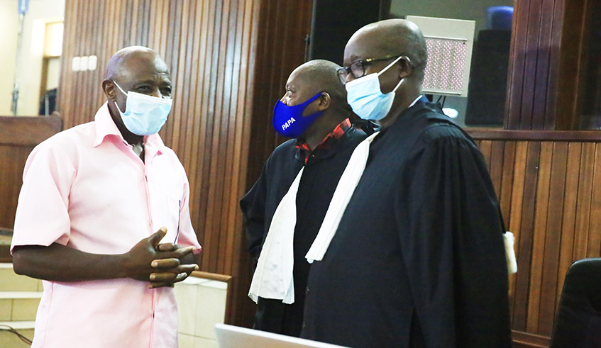 Terror suspect Paul Rusesabagina interacts with his lawyers in the High Court Chamber for International and Cross Border Crimes on February 26, 2021./ Photo by Sam Ngendahimana