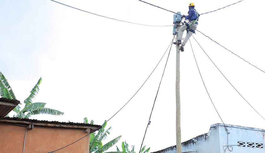A technician connects Gasabo residents to electricity infrastructure. Photo: Craish Bahizi.